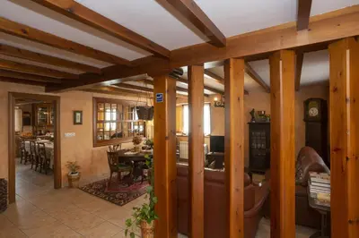 a living room with wooden beams and a dining room at Hotel Rural As Laguas in Tapia de Casariego