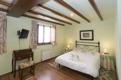 a bedroom with a bed with a piano and a piano at Hotel Rural As Laguas in Tapia de Casariego