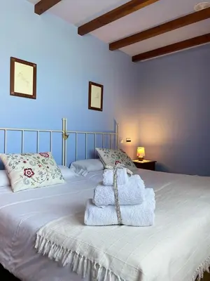 a bedroom with a bed with towels on it at Hotel Rural As Laguas in Tapia de Casariego