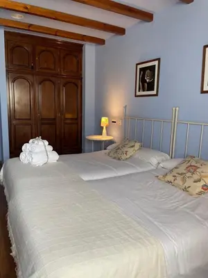 two beds sitting next to each other in a bedroom at Hotel Rural As Laguas in Tapia de Casariego