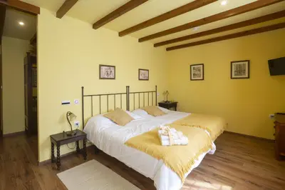 a bedroom with a bed with two towels on it at Hotel Rural As Laguas in Tapia de Casariego