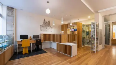 an office with a desk and a computer in a room at Albergue The Last Stamp in Santiago de Compostela