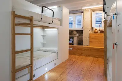 a room with bunk beds and a fireplace at Albergue The Last Stamp in Santiago de Compostela