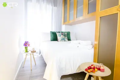 a small bedroom with a bed and a table with fruit on it at CON PARKING, LocalizacIon Sensacional in Santiago de Compostela