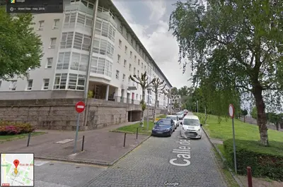 a street with cars parked in front of a building at CON PARKING, LocalizacIon Sensacional in Santiago de Compostela