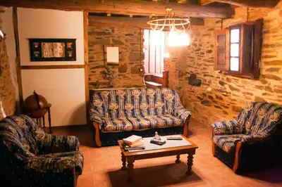 a living room with two couches and a coffee table at CASA RURAL BIERZO ENCANTADO in Valle de Finolledo