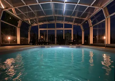 a swimming pool in a house with a ceiling at Casa de Fares in A Estrada