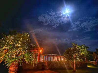 a house at night with a light in the sky at Casa de Fares in A Estrada