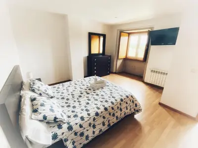a bedroom with a bed with a comforter on it at Casa de Fares in A Estrada