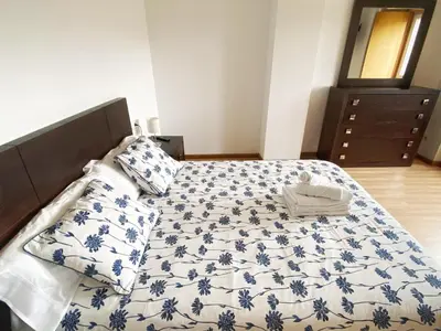a bedroom with a bed with a blue and white blanket at Casa de Fares in A Estrada