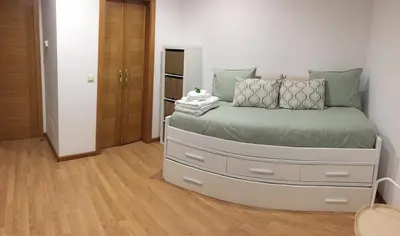 a bedroom with a large bed with a large chest of drawers at Casa de Fares in A Estrada
