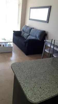 a living room with a couch and a table at Panoramico Playa de Altar I in Barreiros