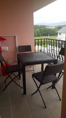 a black table and chairs on a balcony at Panoramico Playa de Altar I in Barreiros