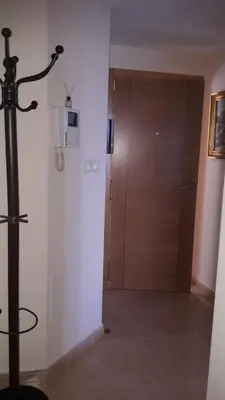 a room with a wooden door and a door at Panoramico Playa de Altar II in Barreiros