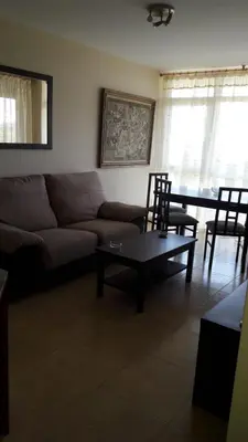 a living room with a couch and a table and chairs at Panoramico Playa de Altar II in Barreiros