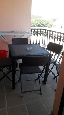 a black table and chairs on a balcony at Panoramico Playa de Altar II in Barreiros