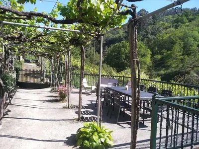 a pergola with a picnic table on a patio at Casa en Viñoas (Ribeira Sacra) in Viñoás