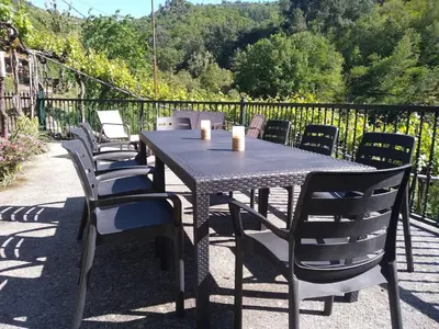 a table and chairs sitting on a patio at Casa en Viñoas (Ribeira Sacra) in Viñoás