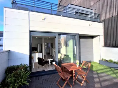 a patio with a table and chairs on a balcony at 4 Apartamentos de Autor in Lugo