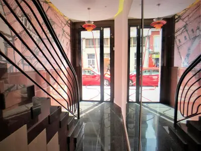 a hallway of a building with glass doors and a street at 4 Apartamentos de Autor in Lugo
