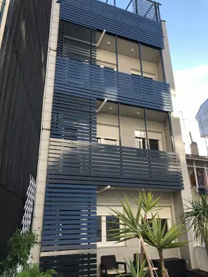 a building with blue balconies on the side of it at 4 Apartamentos de Autor in Lugo