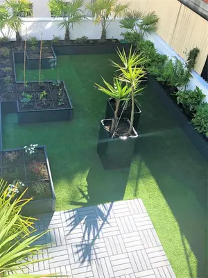 an aerial view of a garden with palm trees and plants at 4 Apartamentos de Autor in Lugo