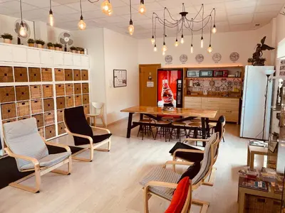 a room with a table and chairs and a dining room at Albergue SIXTOs no Caminho - NO BIKE STORAGE in Santiago de Compostela