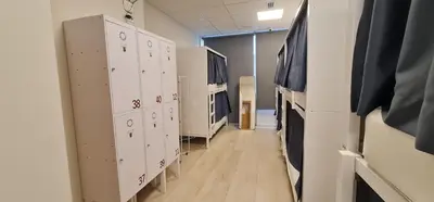 a room with lockers and a hallway in a hospital at Albergue SIXTOs no Caminho - NO BIKE STORAGE in Santiago de Compostela