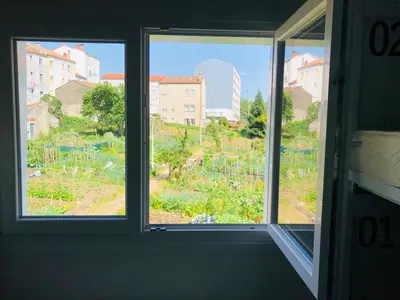 a window in a room with a view of a yard at Albergue SIXTOs no Caminho - NO BIKE STORAGE in Santiago de Compostela