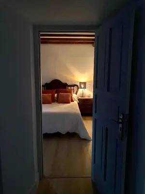 a bedroom with a bed and a door leading into a room at Pena De Roca in Pontevedra