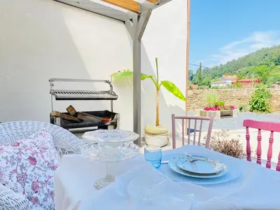 a table with a blue table cloth on a patio at Pena De Roca in Pontevedra