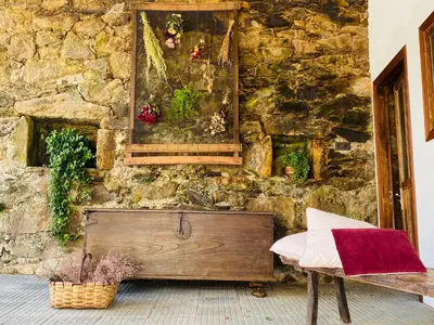 a stone wall with a bench and a painting on it at Pena De Roca in Pontevedra