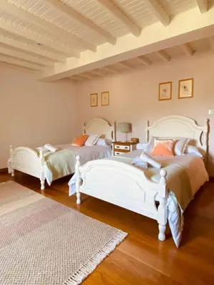 two white beds in a room with wooden floors at Pena De Roca in Pontevedra