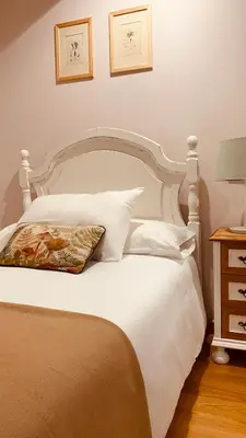 a bedroom with a white bed with a pillow on it at Pena De Roca in Pontevedra