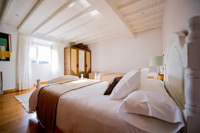 a bedroom with a large white bed with white pillows at Pena De Roca in Pontevedra