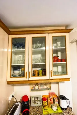 a kitchen with wooden cabinets with dishes inside at Miranda VUT-PO-004637 in Caldas de Reis