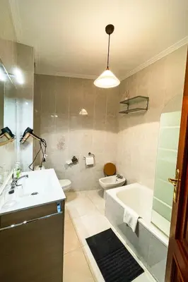a bathroom with a sink and a tub and a toilet at Miranda VUT-PO-004637 in Caldas de Reis