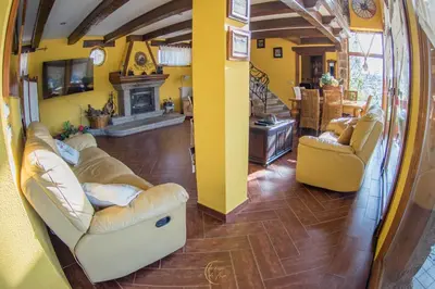 a living room with two couches and a fireplace at Villa Rural 