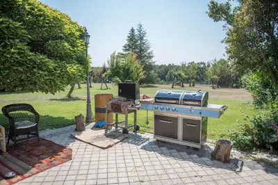 a barbecue grill with a stove top oven in a park at Villa Rural 