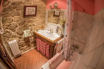 a bathroom with a sink and a stone wall at Villa Rural 