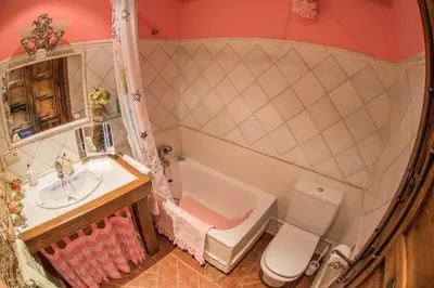 a bathroom with a sink and a tub and a toilet at Villa Rural 