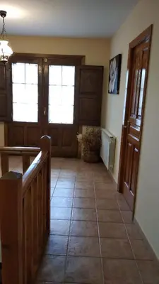 a room with a hallway with doors and a tile floor at Casa Rural Leonor in San Ciprián
