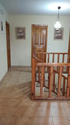 a room with a wooden staircase in a house at Casa Rural Leonor in San Ciprián