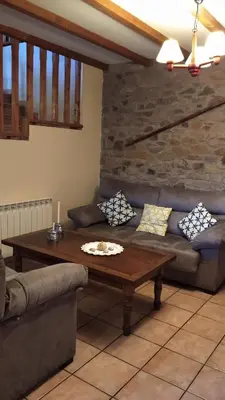 a living room with a couch and a table at Casa Rural Leonor in San Ciprián