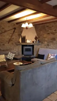 a living room with a couch and a fireplace at Casa Rural Leonor in San Ciprián