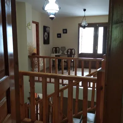 a room with a wooden staircase and a room with a window at Casa Rural Leonor in San Ciprián