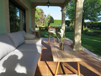 a patio with a couch and a table on a deck at Casa da Agra in A Coruña