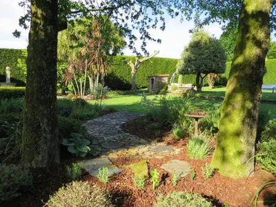 a garden with trees and a stone path at Casa da Agra in A Coruña