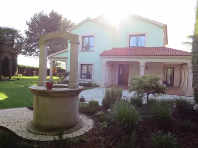 a white house with a fountain in the yard at Casa da Agra in A Coruña