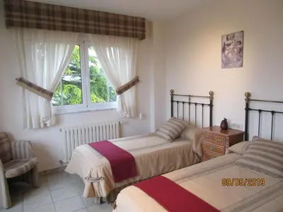 a bedroom with two beds and a window at Casa da Agra in A Coruña